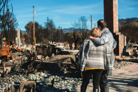 Man and his wife owners, checking burned and ruined of their house and yard after…